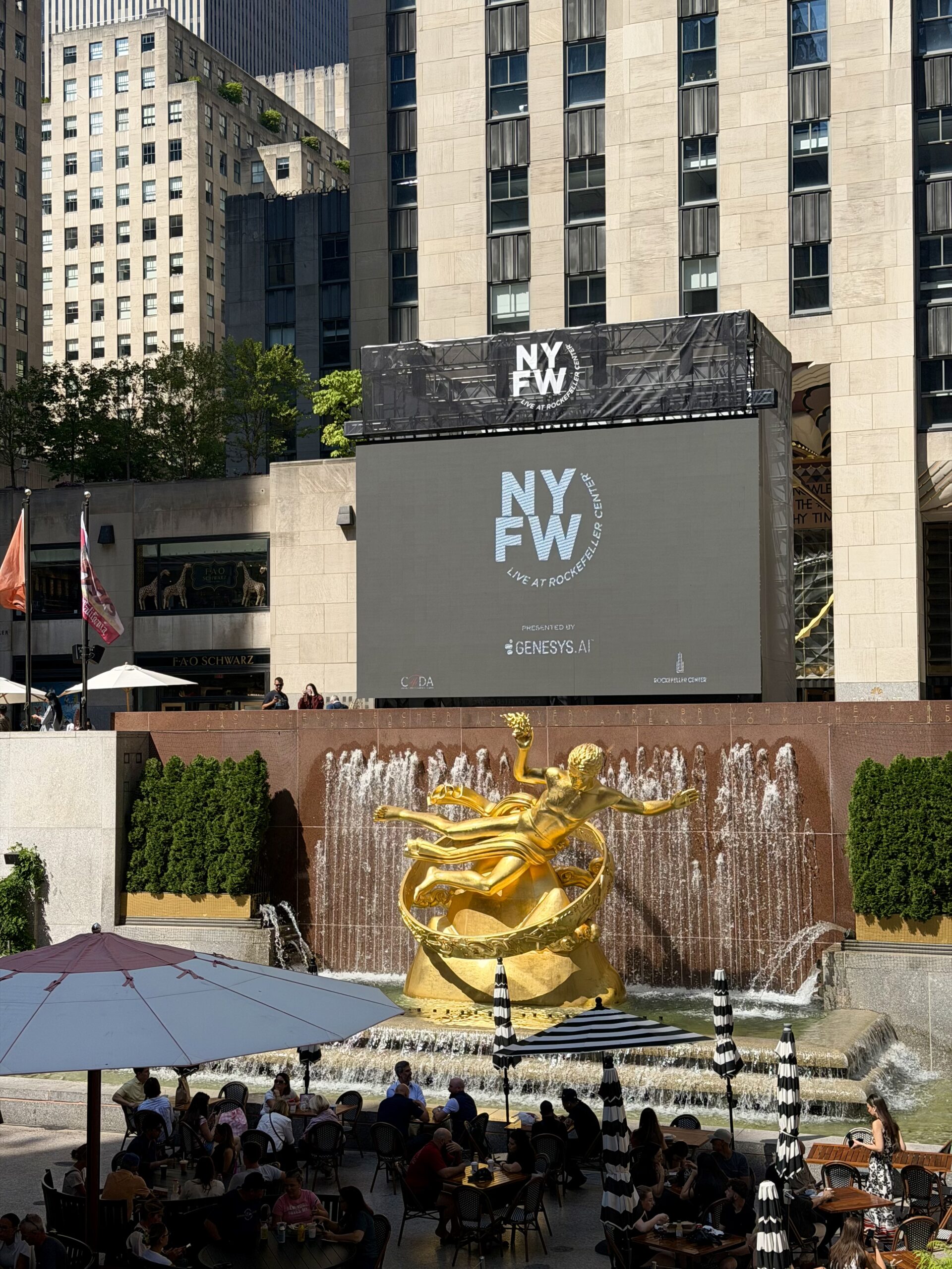 NYFW Live 2026 screen at Rockefeller Center overlooking the Prometheus statue